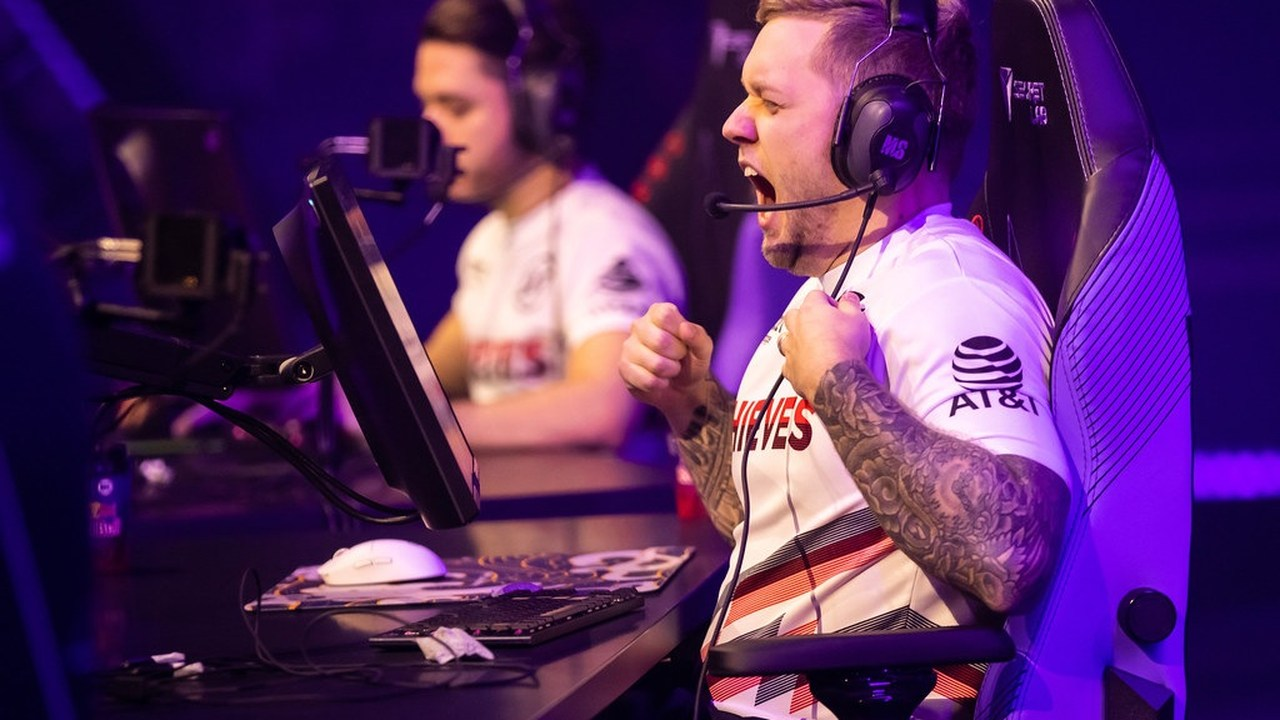 A 100 Thieves player celebrates at his tournament computer